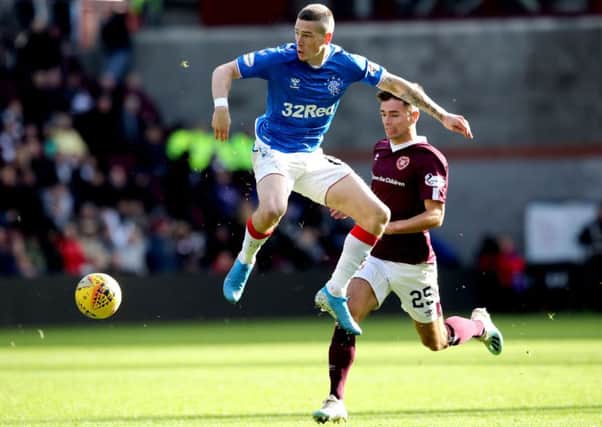 Rangers' Ryan Kent (left) and Heart of Midlothian's Jamie Brandon battle for the ball during the Ladbrokes Scottish Premiership match at Tynecastle Park, Edinburgh. Pic by PA.