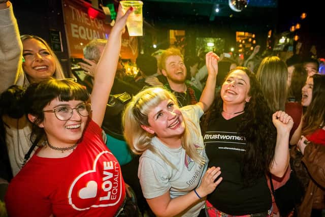 Martha Brown (left, grey t-shirt) with her partner Louise McCullough (right, black t-shirt) and equal marriage supporters at Maverick Bar, Belfast, celebrate the change to abortion and same sex marriage laws in Northern Ireland at 00:01.