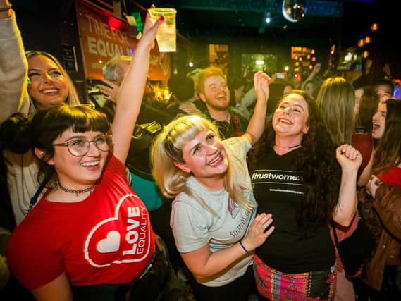 Martha Brown (left, grey t-shirt) with her partner Louise McCullough (right, black t-shirt) and equal marriage supporters at Maverick Bar, Belfast, celebrate the change to abortion and same sex marriage laws in Northern Ireland at 00:01.