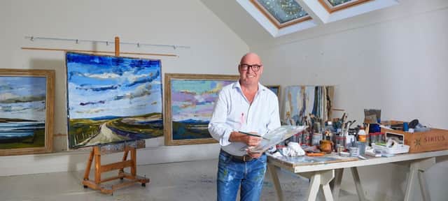 Martin Mooney at his studio in Donegal with a series of his landscapes