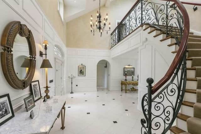The property features an impressive double height entrance hall with vaulted ceiling, feature staircase