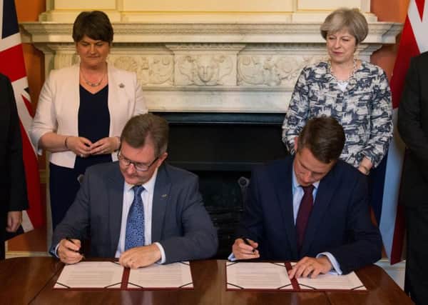 Then Prime Minister Theresa May with DUP leader Arlene Foster (left) in 2017, as DUP MP Sir Jeffrey Donaldson (second right) and Chief Whip Gavin Williamson sign deal in which DUP support the minority Conservative government. Photo: Daniel Leal-Olivas/PA Wire