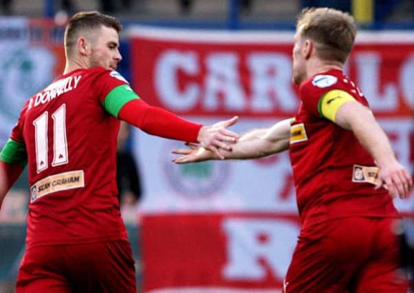 Cliftonville captain Chris Curran (right) offers his congratulations to Rory Donnelly following the forward's goal in victory over Glenavon. Pic by INPHO.