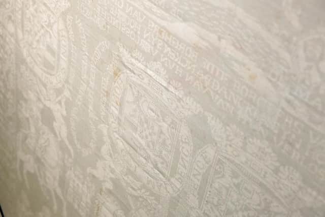 A close up of the 1675 King William III damask linen tablecloth