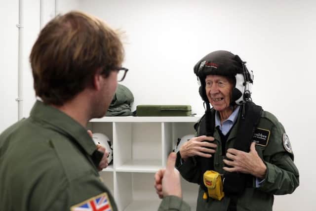 RAF veteran John Allinson is fitted with a helmet prior to a flight in a Spitfire at Solent Airport, who has achieved the "ambition of a lifetime" by taking a flight in a Spitfire organised as a thank you for his "selfless" caring for his wife.