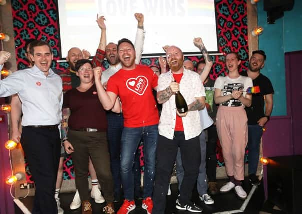LGBT campaigners celebrated in Belfast after MPs voted to bring gay marriage to NI in July