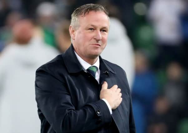 Michael O'Neill offers his thanks to the Northern Ireland fans following the final whistle at the National Stadium on Saturday. Pic by PressEye Ltd.