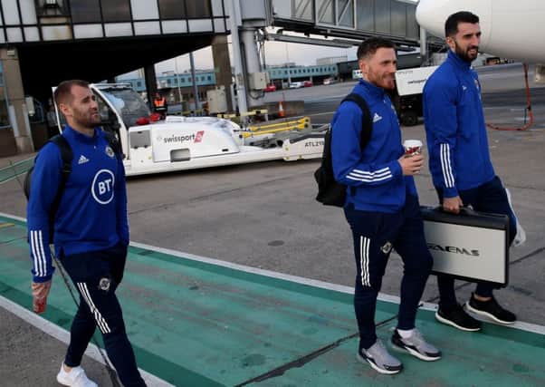 Corry Evans on his way to board the plane for Germany flanked by Niall McGinn (left) and Conor McLaughlin. Pic by PressEye Ltd.