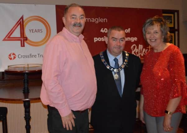 Ian and Pauline Bothwell of Crossfire Trust celebrate 40 years of their work in south Armagh at Crossmaglen Rangers GAC on November 9, 2019, with Newry Mourne and Down District Council Deputy Chairman Terry Andrews.
