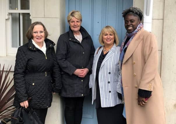 Joy Scott, Group Chair at Clanmil, Carol Mc Taggart, Clanmil Group Director of Development and Siobhan Brown, Clanmil Construction and Defects Manager welcome Karen Mc Laughlin to her new home