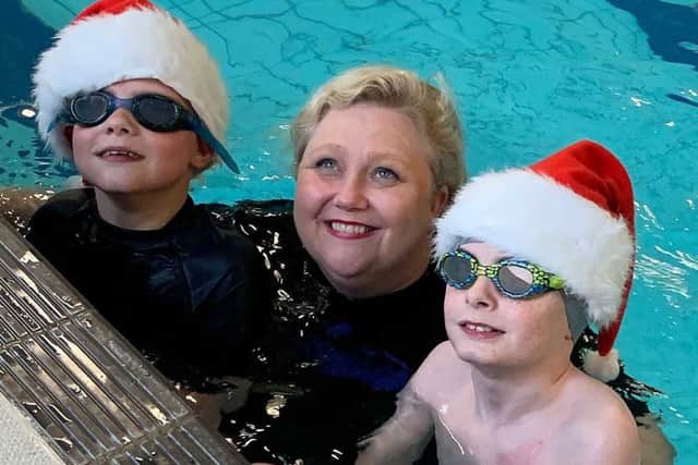 Pictured are Ethan Pollock and Oliver Dickey with swimming coach Sindy Stewart