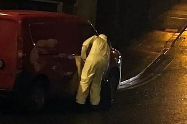 A forensics expert examines a vehicle following the sudden death of a baby in Keady, Co Armagh. PACEMAKER BELFAST