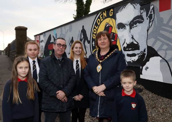 Dave Boy McAuley and the Mayor of Mid and East Antrim, Cllr Maureen Morrow, alongside pupils from Moyle Primary School and Larne High School at the new mural.