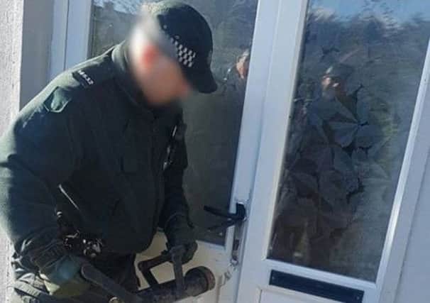 Police forced the door to gain entry to the premises (PSNI image).