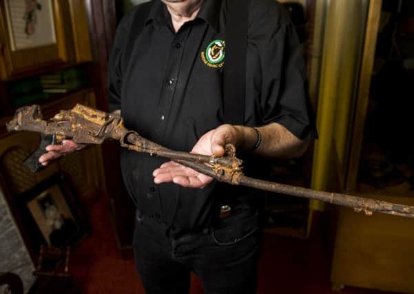 Kevin Carson, curator of  Roddy McCorley Society living history museum in Belfast holds the mangled metal frame of an L1A1 Self-Loading Rifle. The gun was reportedly found on the Omeath foreshore approximately a year after the Narrow Water IRA attack that killed 18 soldiers. Photo: Liam McBurney/PA Wire