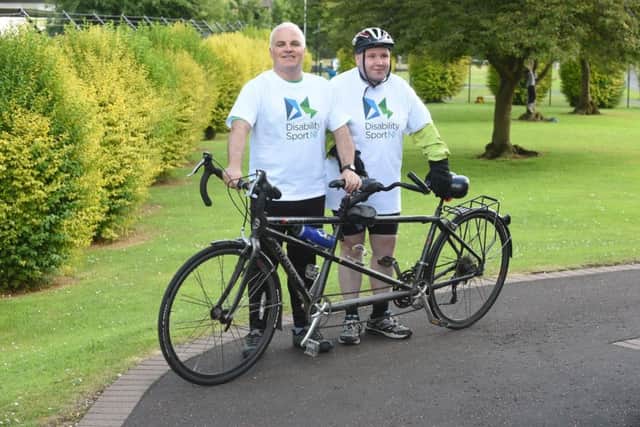 Barry Macaulay and Thomas Quigley with a tandem bike.
