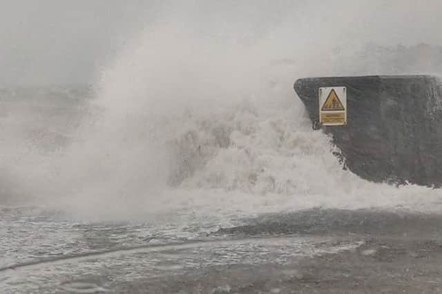 Waves crashing over the sea wall at Carrickfergus.