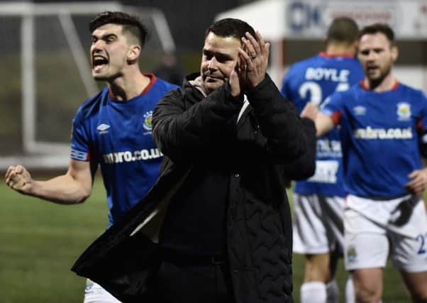Linfield boss David Healy and his players celebrate beating Cliftonville on Monday night. Pic by Pacemaker.