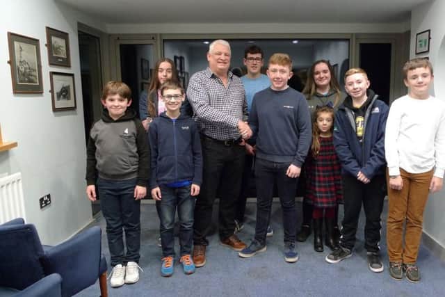 James Corbett, CAYC junior captain, agreeing the sponsorship deal of CAYC Spring Series 2020, on behalf of all junior members, with commodore Paul Abraham.