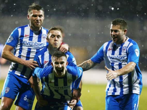 Alexander Gawne is mobbed by his Coleraine team-mates after scoring the winner against Cliftonville