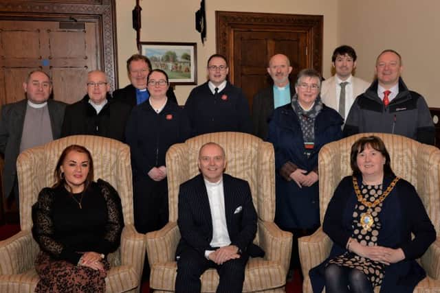 The Rt Rev Dr William Henry (seated centre), Moderator of the Presbyterian Church, with Anne Donaghy, (seated left)  CEO of Mid and East Antrim Borough Council, the Mayor, Cllr Maureen Morrow (seated right) and clergy from Larne and district on their visit to Larne Town Hall. INLT 05-001-PSB