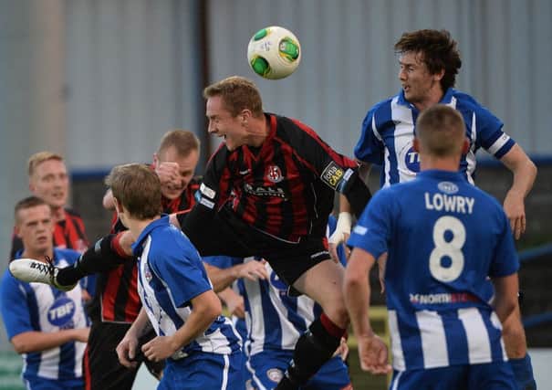 Coleraine's Howard Beverland in action with Crusaders Timmy Adamson