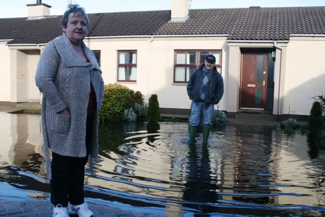 Roisin and Michael outside their homes surrounded by flood water in Churchtown