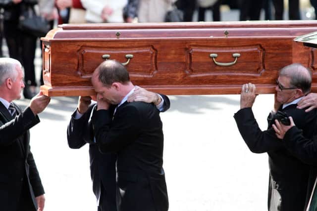 The remains of Gerry Anderson are carried into St. Eugenes Cathedral for funeral Mass.  DER 3414-0415MT.