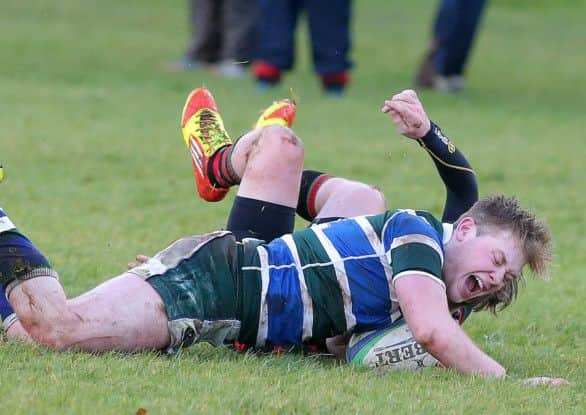 Grosvenor's Thomas Quinn pushes forward to score a try