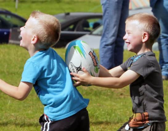 GOT'YA. Two young lads clearly having a ball at Armoy Wasps Mini rugby on Saturday.INBM32-15 046SC.