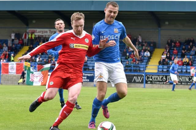Glenavon's Ciaran Caldwell 
and Cliftonville's Chris Curran battle for the ball.