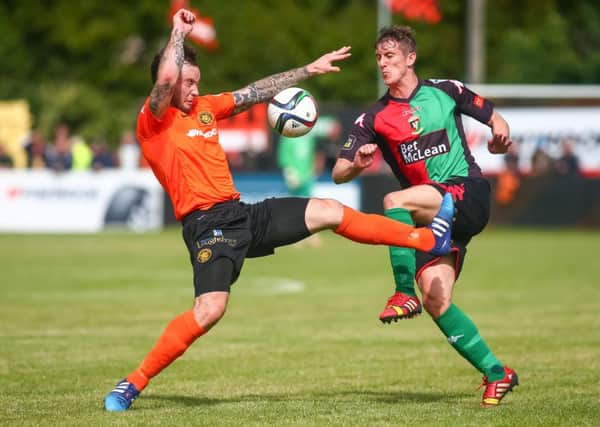 Glentoran's Marcus Kane and Carrick Rangers' Andrew Doyle in action