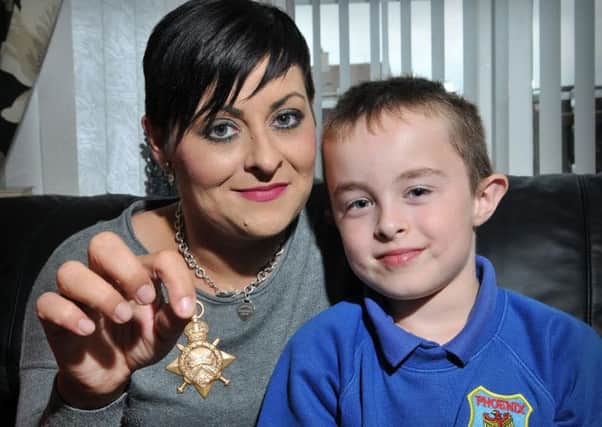 Gillian Henry and her son Shane with the World War 1 medal.INMM4315-356
