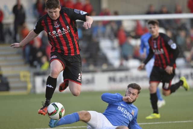 Crusaders Billy Joe Burns in action with Glenavon's Mark Patton.