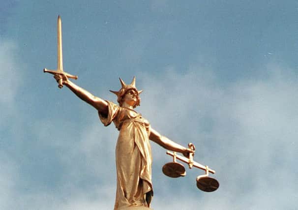 File picture dated 14/8/92 of the Scales of Justice on top of the Old Bailey in London.