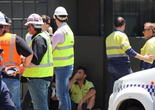 Distraught workmen at the site in Perth where the two Northern Ireland men were killed