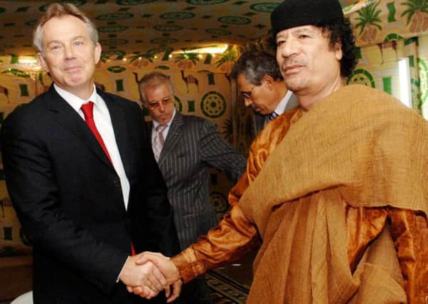 Former Prime Minister Tony Blair meeting Libyan leader Colonel Muammar Gaddafi at his desert base in 2007