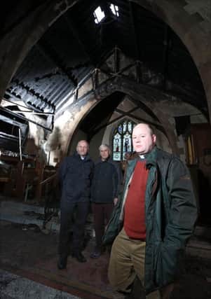 Rev Adrian McLaughlin (right), Rector of St Colman's Parish Church, Dunmurray pictured with the Bishop of Connor, Rev Alan Abernethy and John Williams, Lay Reader, in the burnt out interior of the church