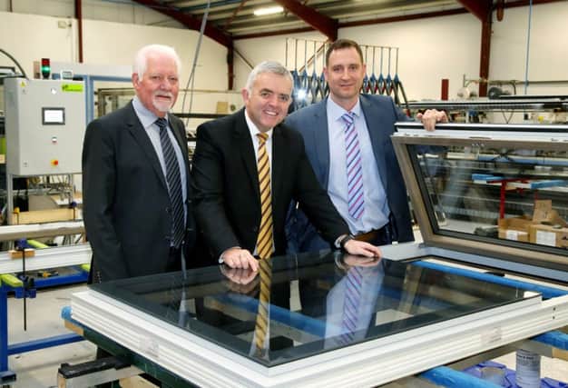 Enterprise Minister Jonathan Bell pictured at Apeer with chairman Austin, left, and MD Asa McGillian