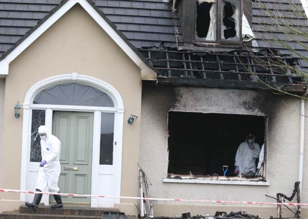 Forensic officers at the scene of the blaze.