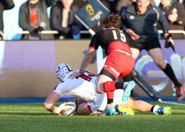 Luke Marshall of Ulster scores the first try as Ben Ransom of Saracens tries to tackle