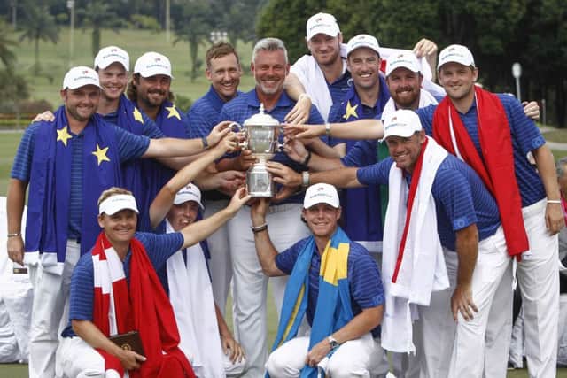 Members of Team Europe, top row left to right, Andy Sullivan of England, Danny Willet of England, Victor Dubuisson of France, Ian Poulter of England, Darren Clarke of Northern Ireland, Chris Wood of England, Ross Fisher of England, Shane Lowry of Ireland, Bernd Wiesberger of Austria, front row left to right, Soren Kjeldsen of Denmark, Matthew Fitzpatrick of England, Kristoffer Broberg of Sweden and Lee Westwood of England,  with their trophy after winning the Eurasia Cup golf tournament at the Glenmarie Golf and Country Club in Subang, Malaysia