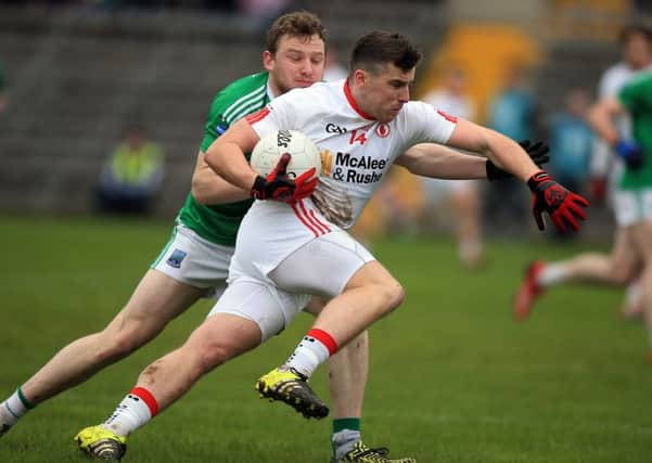Fermanagh's Aidan Breen challenges Tyrone's Connor McAliskey