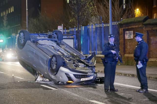 An overturned car at the scene of the incident on the Falls Road