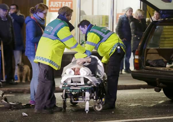 One of the injured victims is taken away after Monday night's incident in west Belfast