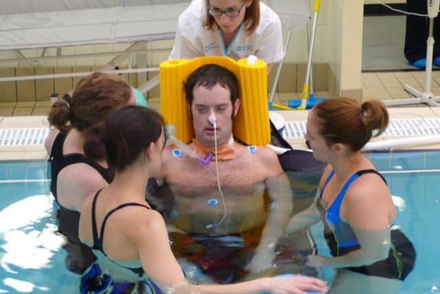 Physiotherapists work with Gareth in the pool in the groundbreaking aqua therapy. INPT04-013