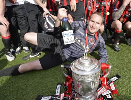 Sean O'Neill celebrates with the Gibson Cup last season