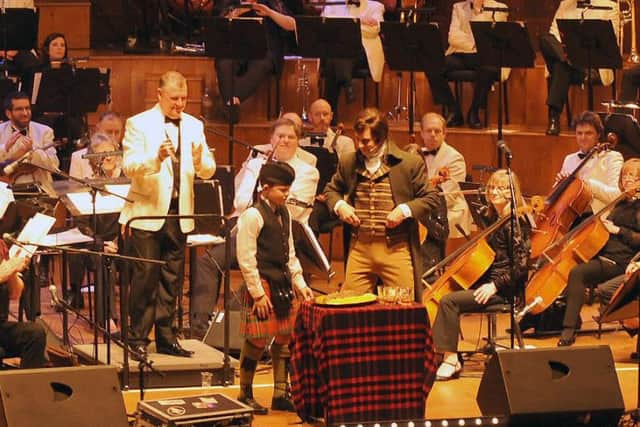 Owen McGregor (Ulster-Scots Agency Juvenile Pipe Band) looks on as Christopher Tait gives the address to the haggis at a Burns Night Concert in the Ulster Hall on Saturday