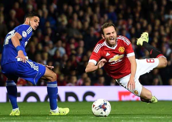 Manchester United's Juan Mata (right) battles for the ball with Ipswich Town's Kevin Bru