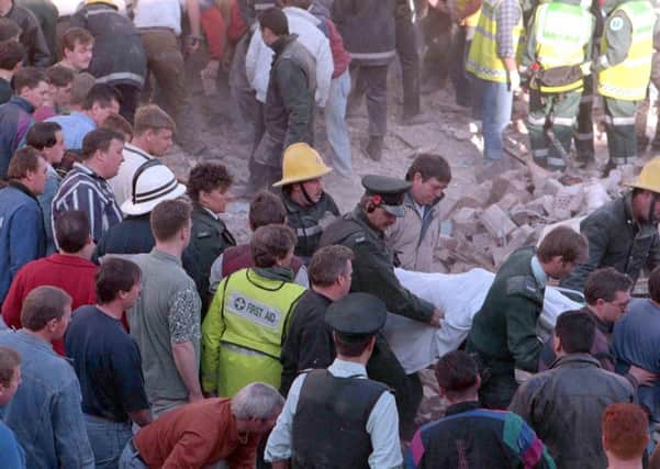 The RUC and other emergency services remove a body from the scene of the Shankill bombing in 1993